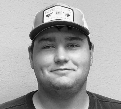 Young man wearing ball cap looking into the camera